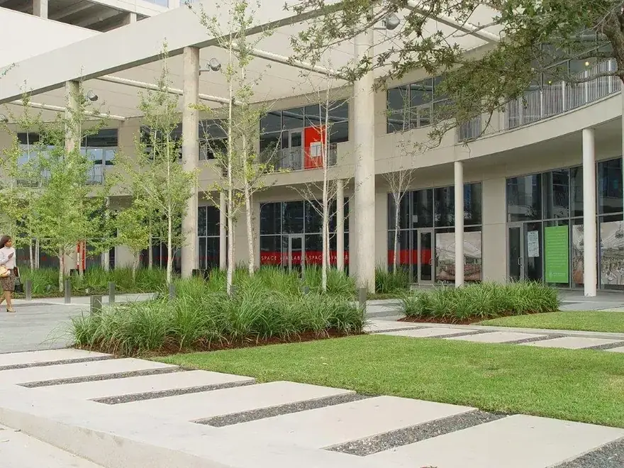 A corporate courtyard colonnade with stepping stones and ornamental grass beds, self-performed hardscape and planting