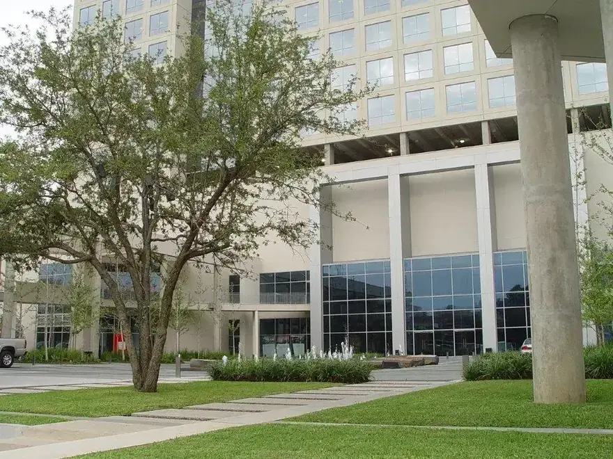 Corporate plaza with a mature live oak over a stepping-stone lawn